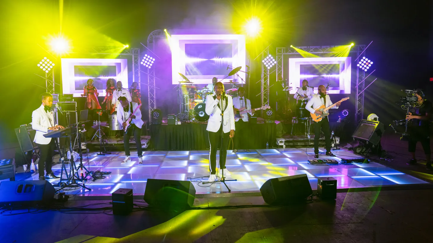 Live band performing on a brightly lit stage