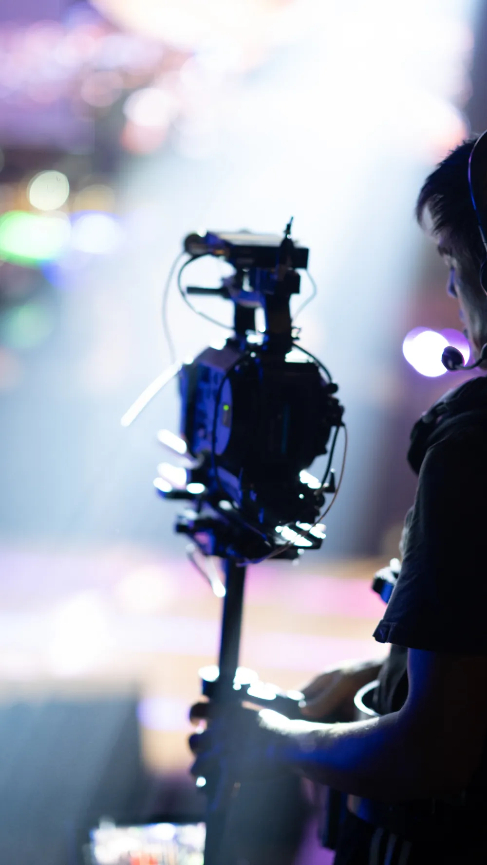 Professional camera operator filming a live production